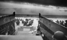 A watercraft unloads troops on a beach.
