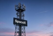 Cell tower with a SpaceX sign at dusk